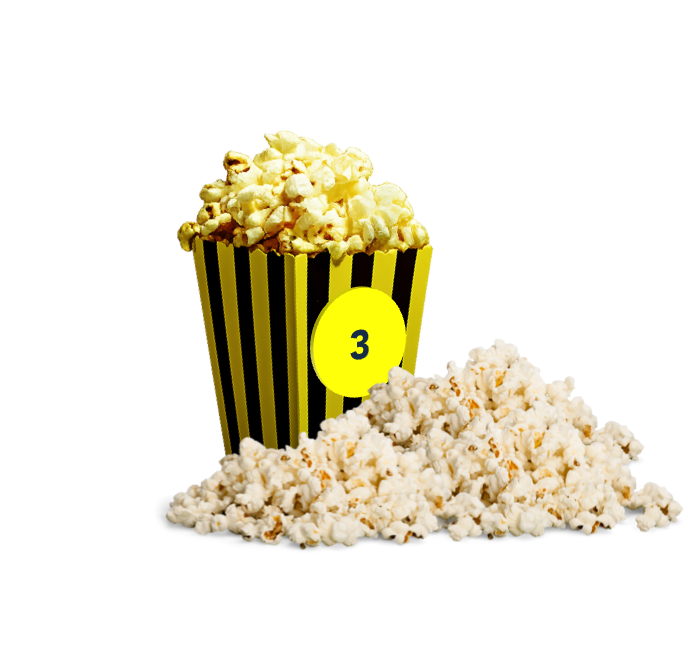 Ein Becher Nr. 3, gefüllt mit Popcorn und viel Popcorn vor und neben dem Becher.